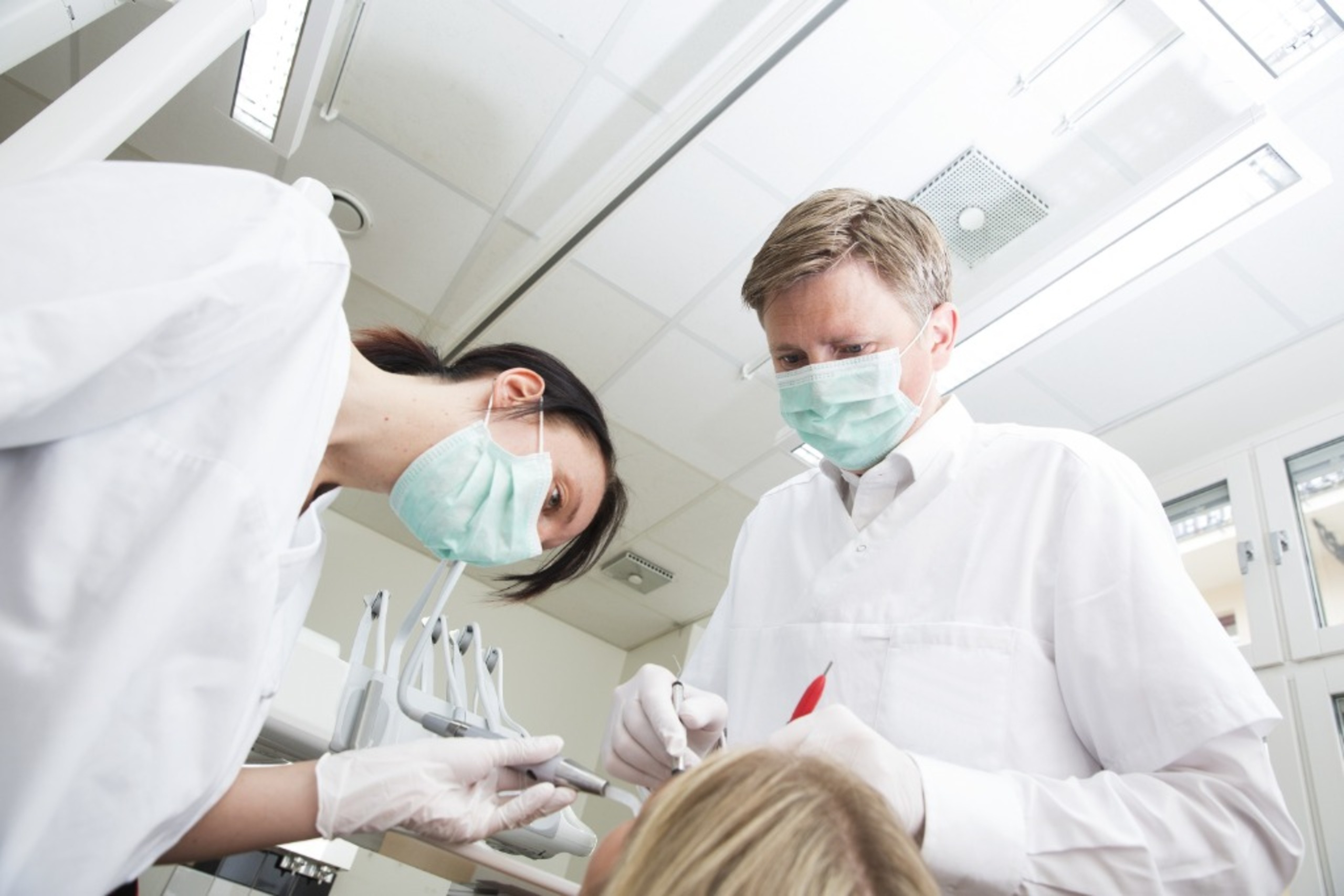 Dentist performing tooth extraction in Winnipeg