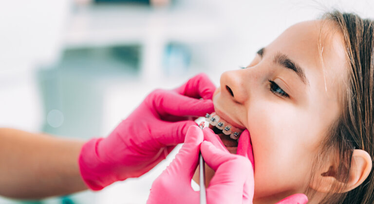 Orthodontist examining little patient in Winnipeg